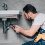 a-Plumber-in-Seattle-fixing-a-sink