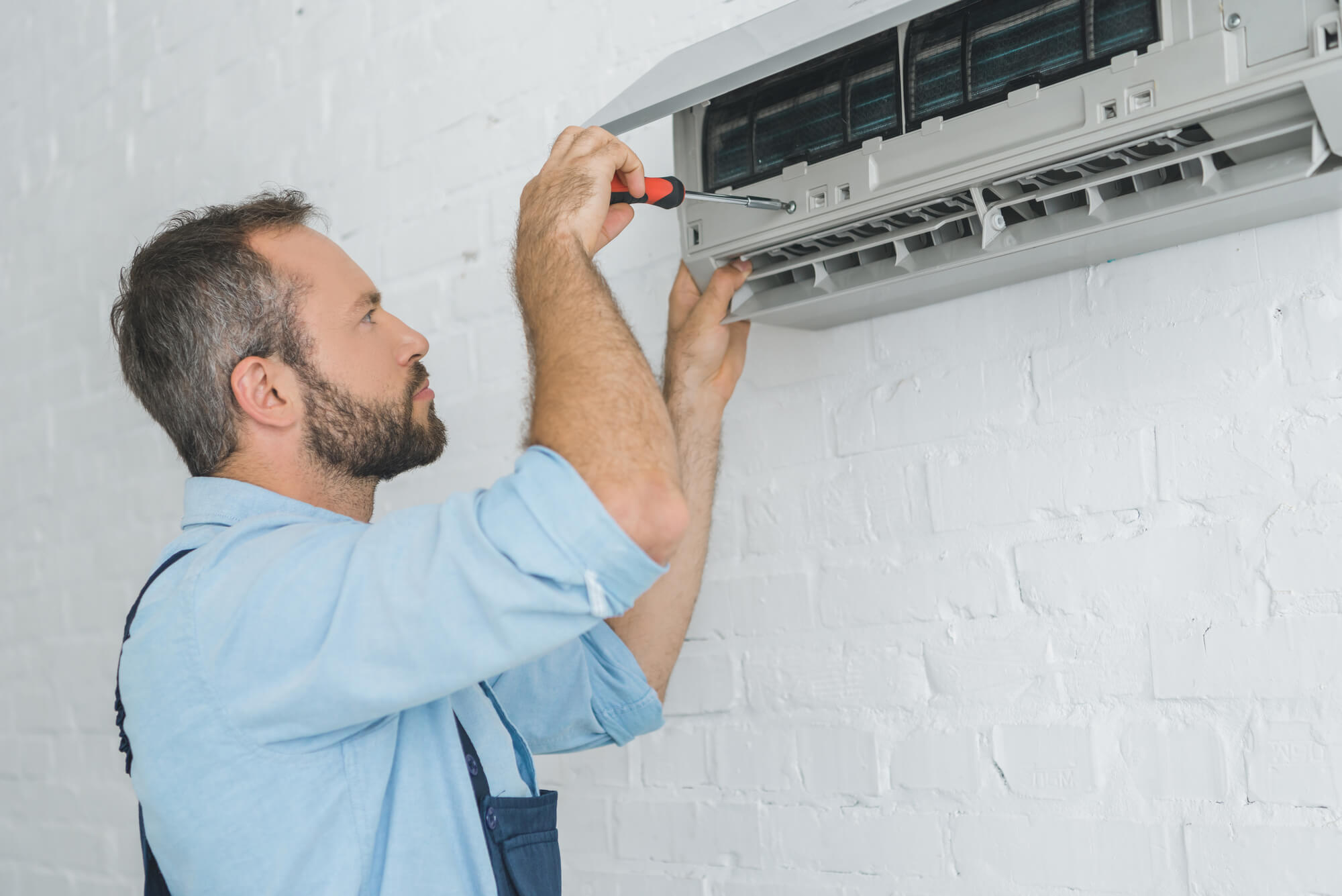 man checking an Air Conditioning in Seattle
