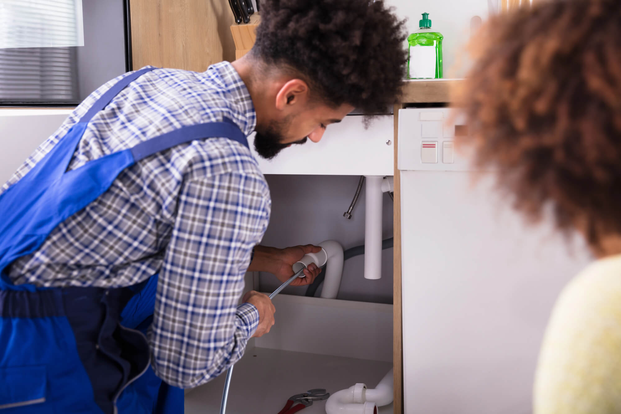 Plumber-Fixing-clogged-drain-in-Seattle