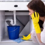 woman-during-plumbing-emergency-calling-a-Plumber-in-Seattle