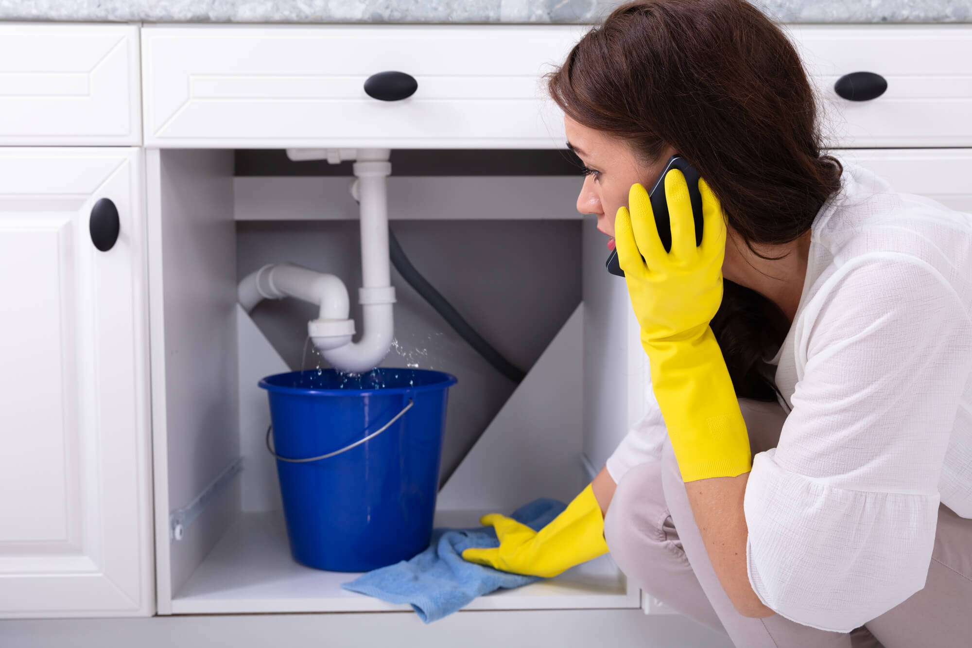 woman-during-plumbing-emergency-calling-a-Plumber-in-Seattle