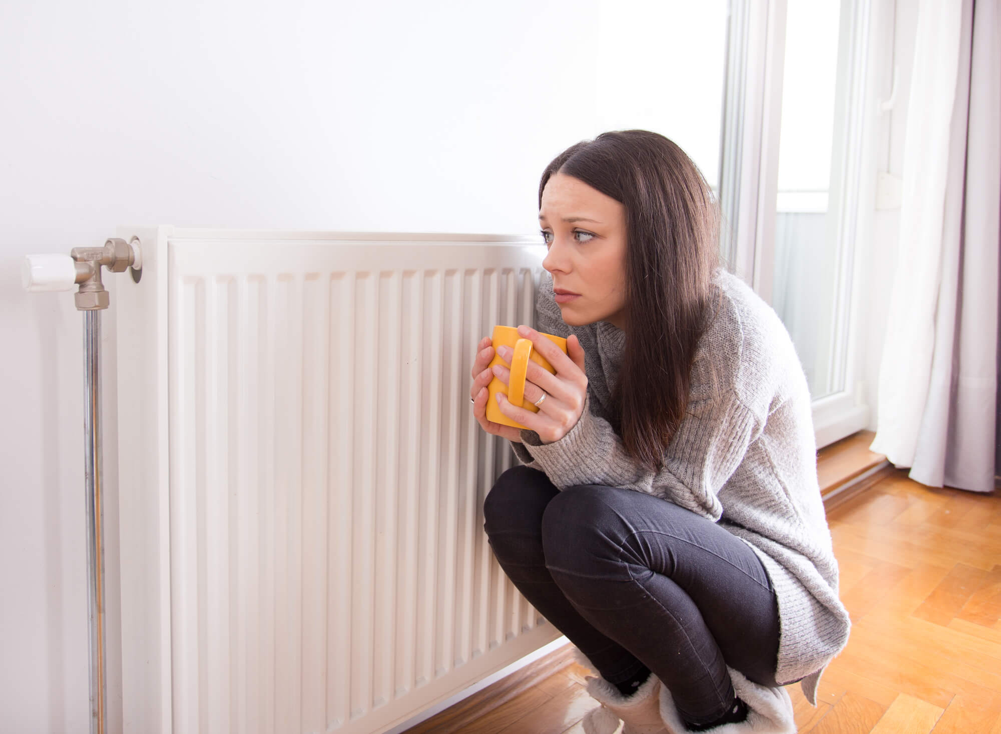 Woman with heating system broken needs Heating Repair in Seattle
